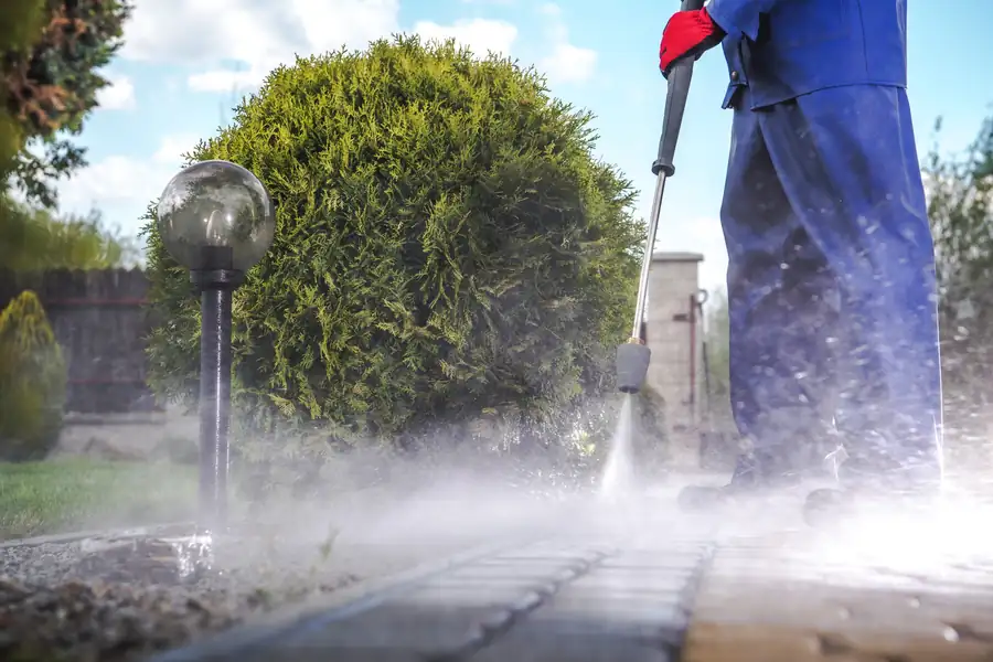 Driveway being jet washed with a high-pressure lance