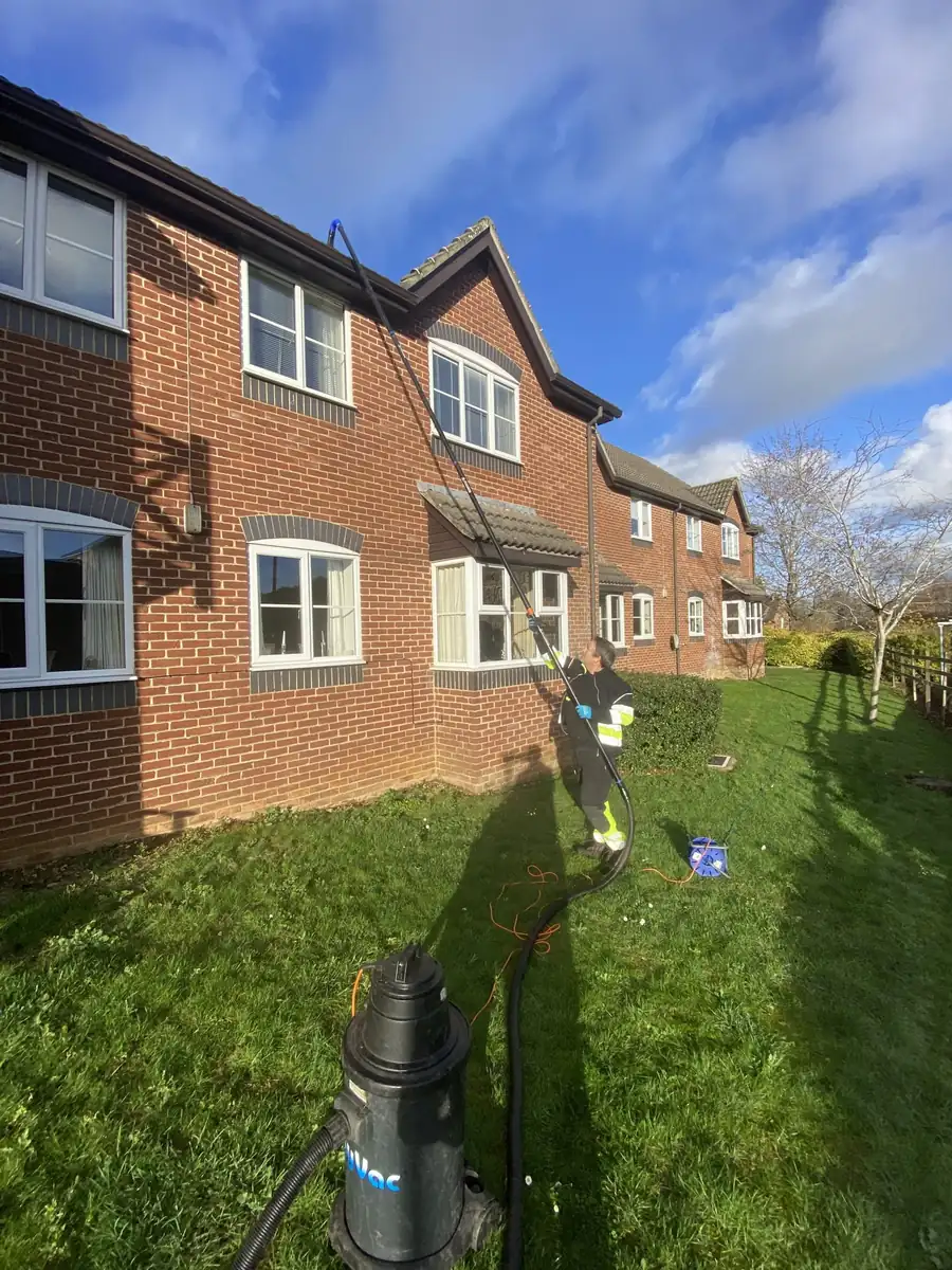 Gutter vacuum equipment clearing gutters on residential flats