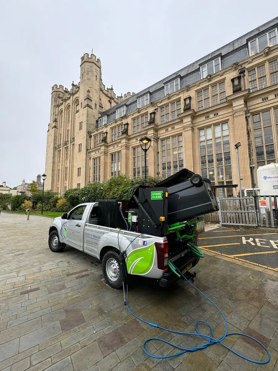 South West Bin Cleaning Co van cleaning bins outside a university building