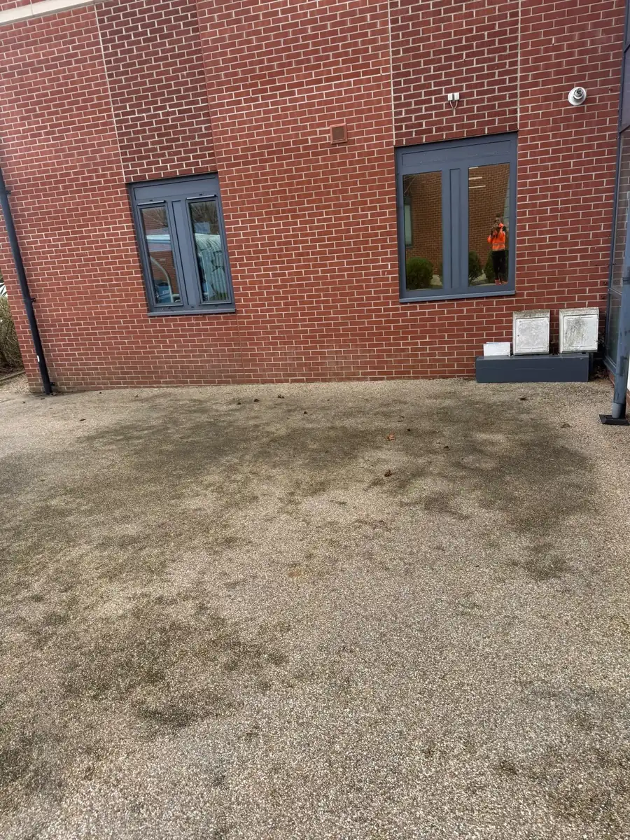 Same gravel area cleared of weeds and moss after clearance